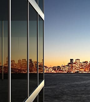 a reflection of the san francisco skyline in the windows of a building