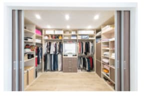 Spacious walk-in closet with shelves and center isle
