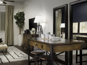 a dining room with a table and two mirrors