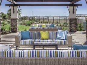 a patio with couches and a table on it