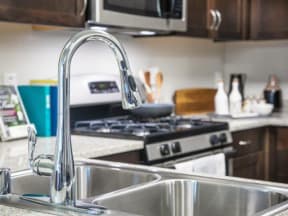 a kitchen with a sink stove and microwave
