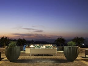 a patio with a fountain and a view of the mountains
