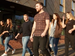 a group of people walking down the street