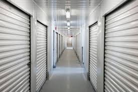 a long hallway of closed doors in a prison