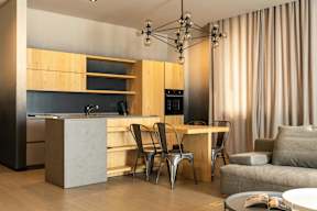 A modern kitchen with a dining table and chairs.