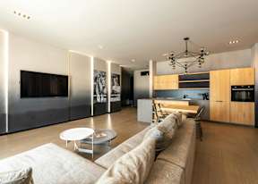 A modern living room with a long couch and a coffee table.