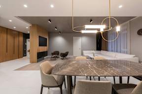 A modern dining room with a large table and chairs.