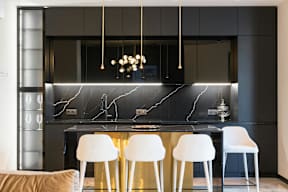 A modern kitchen with a marble backsplash and white chairs.