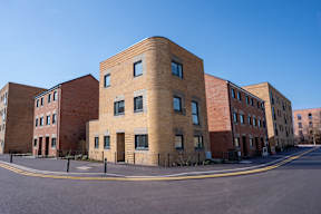 A large brick building with a curved corner.