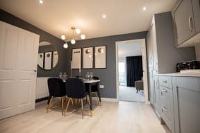a dining room with a table and chairs