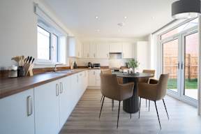A modern kitchen with a dining table set for four.