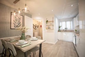 a kitchen and dining room with a table and chairs