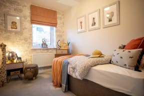 a bedroom with a bed and some pictures on the wall