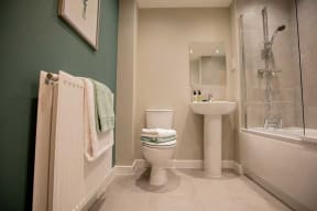 a bathroom with a toilet and a sink and a shower