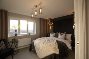 a bedroom with a large bed and a window