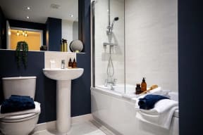 a bathroom with a sink toilet and a shower