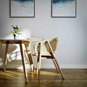 A wooden table with a vase of flowers and a chair in front of it.