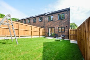 a backyard with a garden and a wooden fence