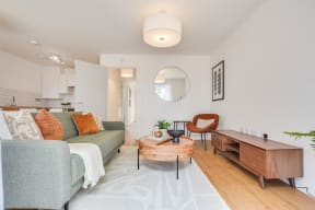 a living room with a green couch and a coffee table