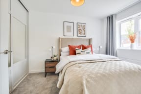 a bedroom with a bed and a window