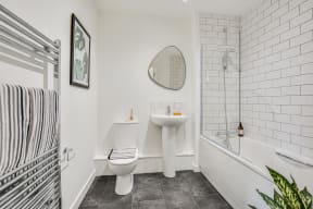 a white bathroom with a toilet sink and shower