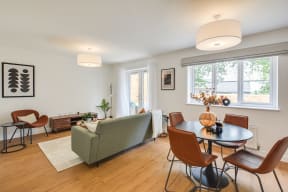 a living room with a table and chairs and a couch