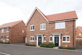 A red brick house with a black door and windows.
