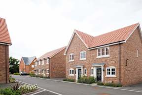 A row of houses with a red roof.
