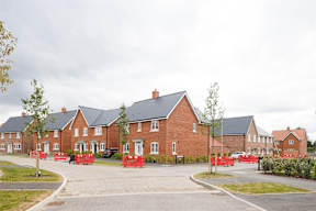 A row of houses with a road in front.