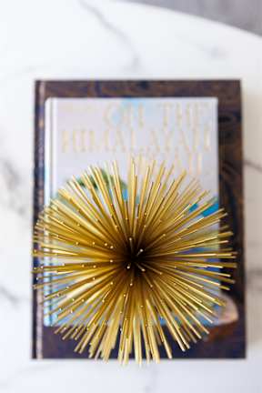 A book with a golden decoration on the cover titled "On the Holiday Way".