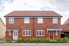 A red brick house with a white door and windows.