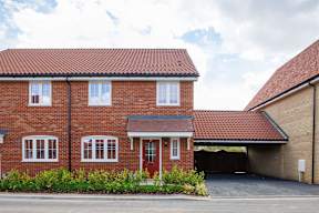 A red brick house with a garage door.