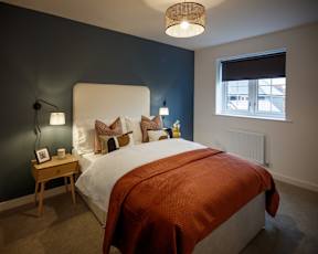 A bedroom with a large bed and a window.