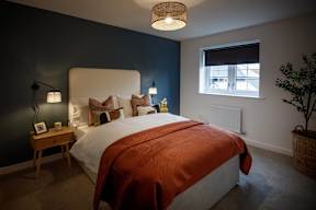 A bedroom with a large bed and a window.