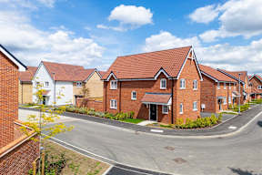 A row of houses with a clear blue sky above them.