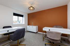 A room with orange walls and a white ceiling with a light fixture.