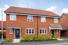 A red brick house with a blue door and windows.