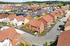 A residential area with houses and cars.