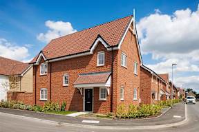 A red brick house with a black door and windows.