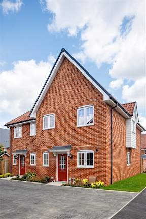 A red brick house with a white garage door.
