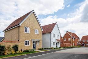 A row of houses with a driveway in front.