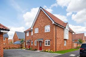A red brick house with a white garage door.