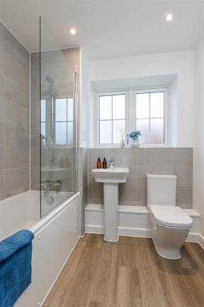 A bathroom with a toilet, sink, and bathtub.