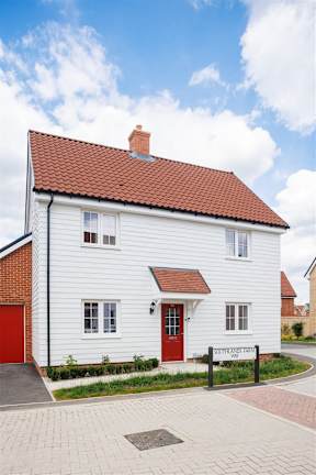 A white house with a red door and a sign that says "Southlands".