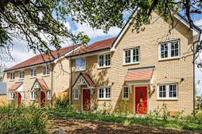 A row of houses with red doors and windows.