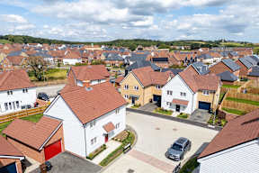 A residential area with houses and cars.