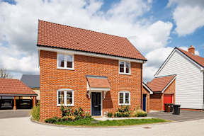 A red brick house with a black door and windows.