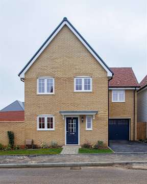 A brick house with a blue door and windows.