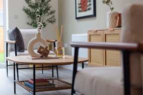 A living room with a round table and a chair.