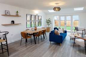 A living room with a dining table and chairs.